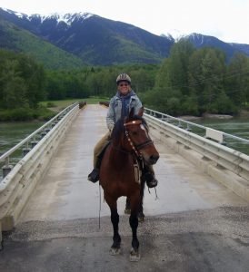 Birgit rides Belle on a trail ride